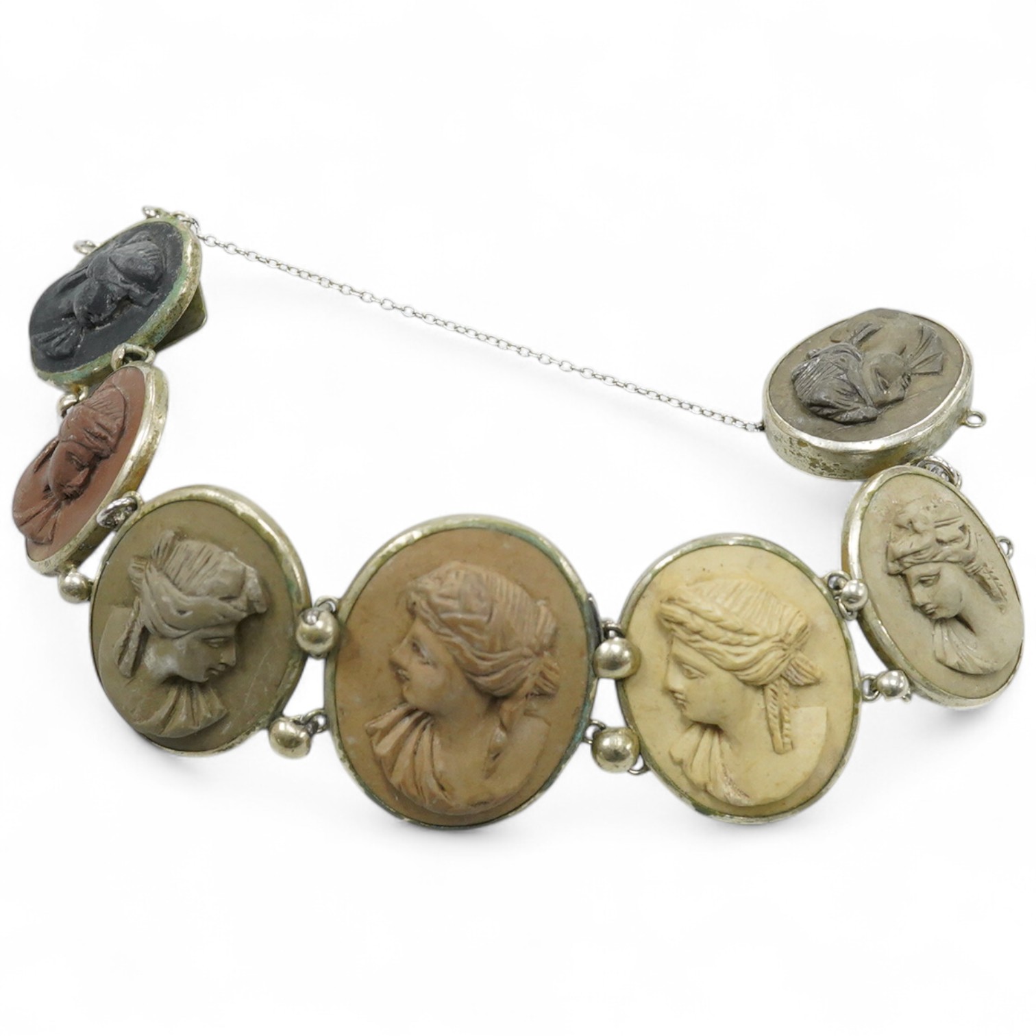 A Victorian base metal bracelet, set with seven graduated lava cameos, carved with the busts of lady's to dexter and sinister, approximately 16.5cm.